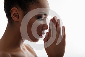 Serene girl holding palms together in front of face