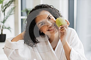Serene healthy female after bath taking pleasure of fresh apple fruit aroma