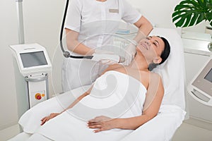 Serene lady taking procedure in wellness center