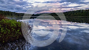 Serene lake reflection with purple sky