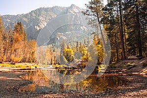 Serene lake surrounded by a colorful autumn mountain landscape