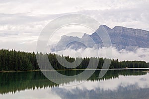 Serene lake is surrounded by snow-capped mountains inBanff, Alberta, Canada