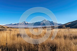 serene landscape featuring mountain range and clear blue skies