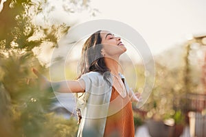 Serene latin woman enjoy sunset with gratitude