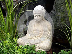Serene little Buddha in garden