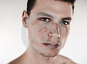 Serene male having mud on nose