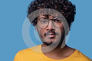 Serene man in trendy spectacles staring ahead