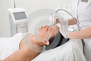 Serene mature lady taking rejuvenation procedure at spa