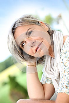 Serene mature woman sitting outdoor