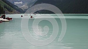 Serene Mountain Lake with Canoeists Enjoying the Scenic Outdoors