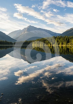 Serene Mountain Lake Reflection with Blue Sky and Clouds