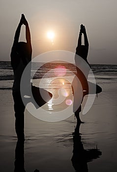 Serene People In The Beach Doing Yoga In The Sunset Concept