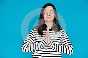 Serene Portrait of a Beautiful Young Woman Meditating with Closed Eyes and Palms, Inner Peace and Relaxation, Isolated