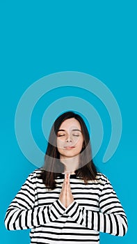 Serene Portrait of a Beautiful Young Woman Meditating with Closed Eyes and Palms, Inner Peace and Relaxation, Isolated