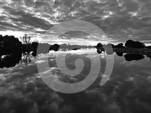 Serene river with cloud reflections