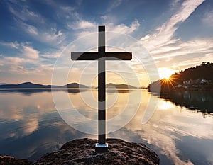 A serene scene of a cross standing on a calm lake with a beautiful sky background