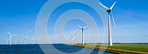 A serene scene in the Netherlands Flevoland, with a picturesque row of wind turbines in Spring