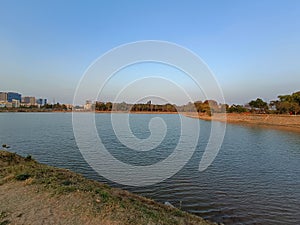 A serene and scenic view of the Narulahalli Lake in Bangalore during sunset time