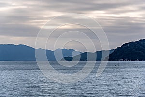 Serene Seascape with Distant Mountains