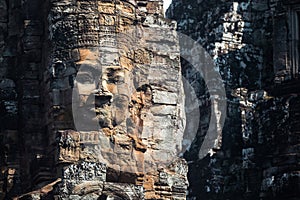 Serene and smiling stone face on Bayon temple photo