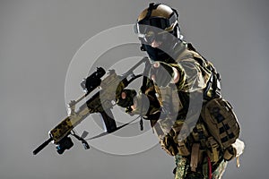 Serene soldier gesticulating arms and keeping weapon