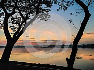 Serene Sunrise Silhouettes by the Lake photo