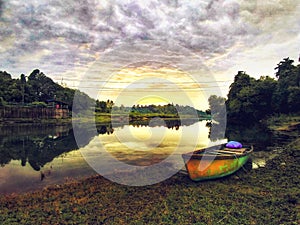 A serene Sunset at the countryside with clear blue water and cloudy sky