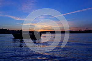 Serene Sunset Escapade: A Captivating Image of Two People Enjoying a Scenic Boat Journey Together