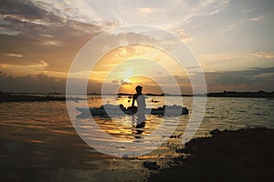 Serene sunset in the lake and boatman