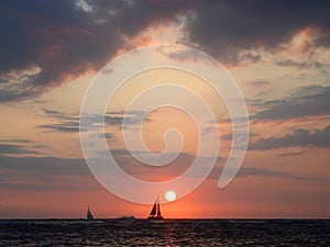 Serene Sunset over the Ocean with Sailboat in Waikiki, Hawaii