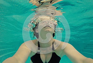 Serene under water selfie of woman in a pool