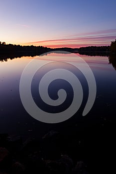 Serene view of calm lake and sunset clouds