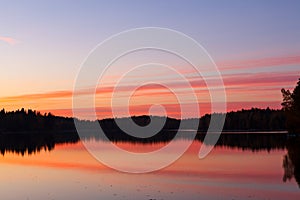 Serene view of calm lake and sunset clouds