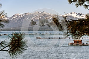 Serene view of Lake Tahoe and the snow capped Sierra Nevada mountains.