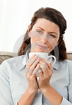 Serene woman holding a cup of coffee