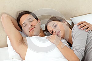 Serene woman lying on her boyfriend's arms