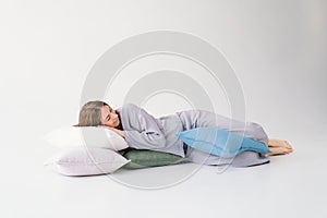 Serene Woman Resting Peacefully With White Pillow on a Light Background