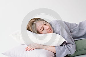 Serene Woman Resting Peacefully With White Pillow on a Light Background