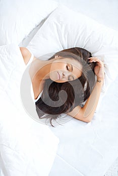 Serene woman sleeping in bed