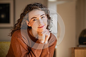 Serene young woman looking at camera