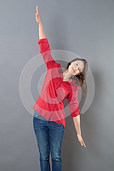 Serene young woman using her arms open wide to fly