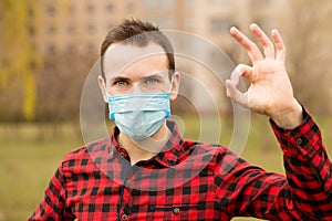 Serenity man wearing protective mask show gesture ok using hand up walk