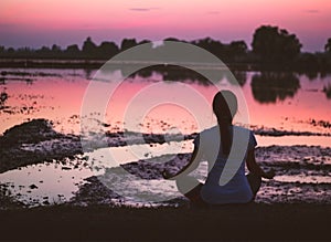 Serenity and yoga practicing, meditating at sunset background