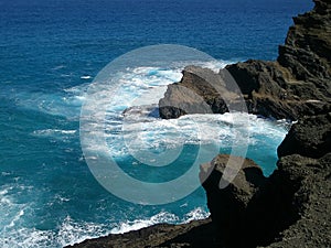 Serf and rocks on Island of Oahu Hawaii photo