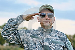 Sergeant in sunglasses saluting portrait.