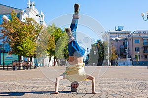 Sergey Pustovoyt. Man dancing yellow shirt blue jeans