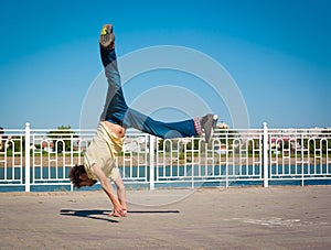 Sergey Pustovoyt. Man dancing yellow shirt blue jeans