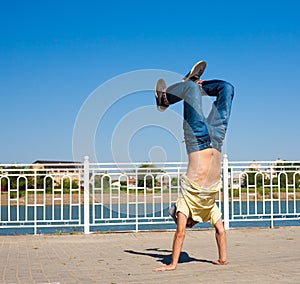 Sergey Pustovoyt. Man dancing yellow shirt blue jeans