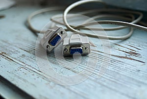 Serial communications connector RS 232. Isolated on wood background.