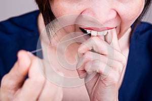 Series of Asian woman flossing teeth with oral floss